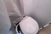 Compact marine toilet in a 2022 Dehler 30 sailboat bathroom.