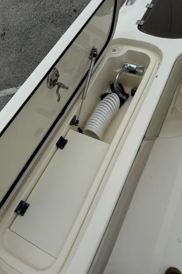  Yacht Photos Pics 2011 Scout 282 XSF boat storage compartment with hose and faucet.