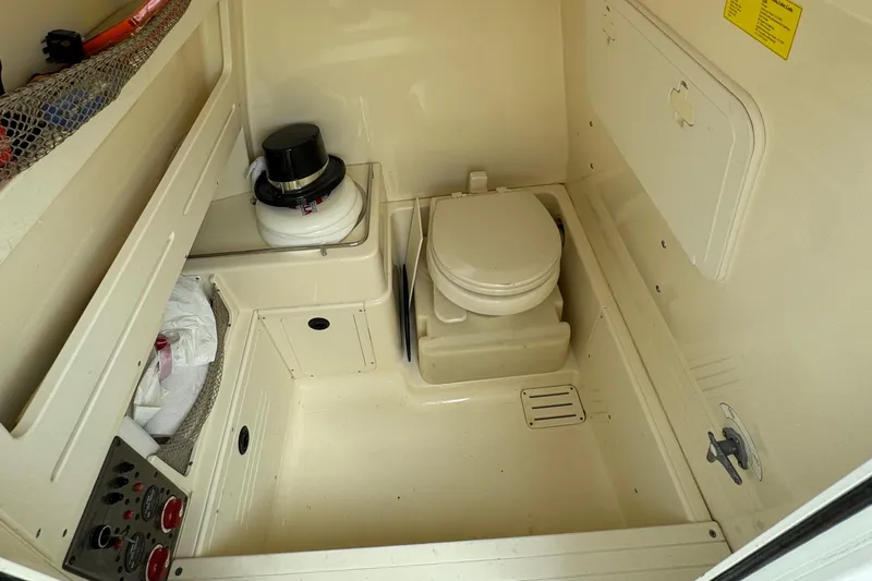  Yacht Photos Pics 2011 Scout 282 XSF boat interior with compact marine toilet.