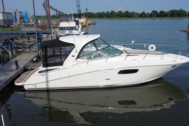  Yacht Photos Pics 2012 Sea Ray 370 Sundancer yacht docked at a marina, calm water, clear sky.