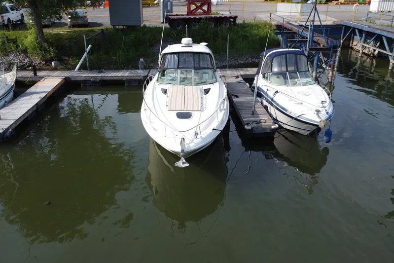  Yacht Photos Pics Sea Ray 370 Sundancer 2012 docked beside another boat in a marina.