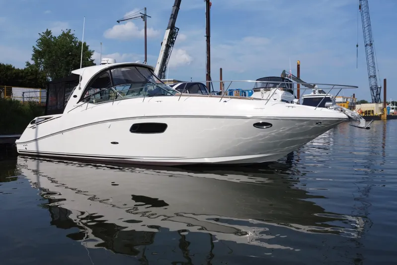  Yacht Photos Pics 2012 Sea Ray 370 Sundancer yacht docked in a marina, reflecting on calm water.