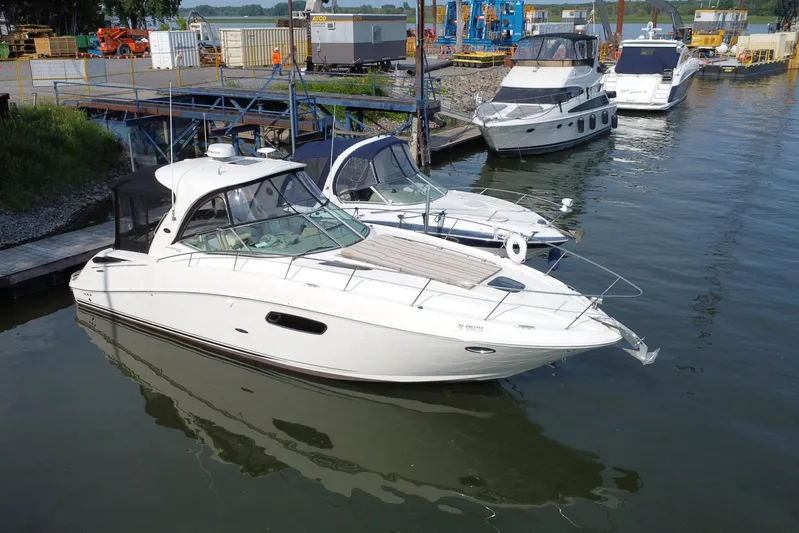  Yacht Photos Pics 2012 Sea Ray 370 Sundancer yacht docked at marina with other boats.