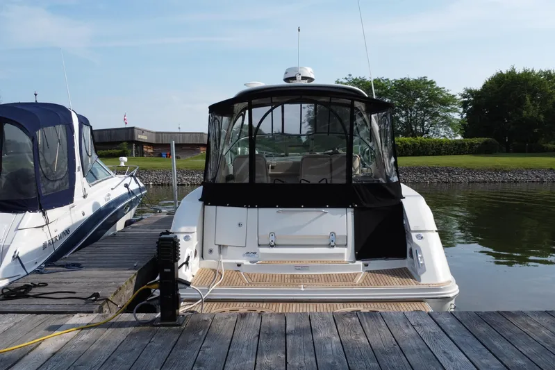  Yacht Photos Pics 2012 Sea Ray 370 Sundancer docked at a marina, rear view with canopy.