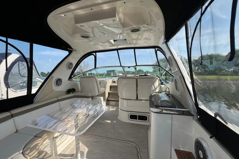  Yacht Photos Pics Luxurious interior of 2012 Sea Ray 370 Sundancer yacht with seating and panoramic windows.