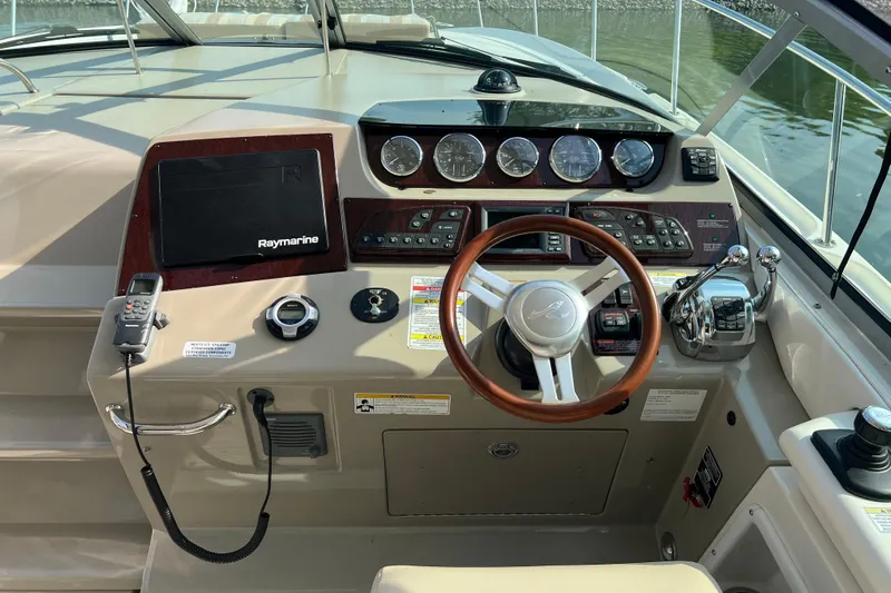  Yacht Photos Pics Cockpit of 2012 Sea Ray 370 Sundancer with steering wheel and navigation controls.