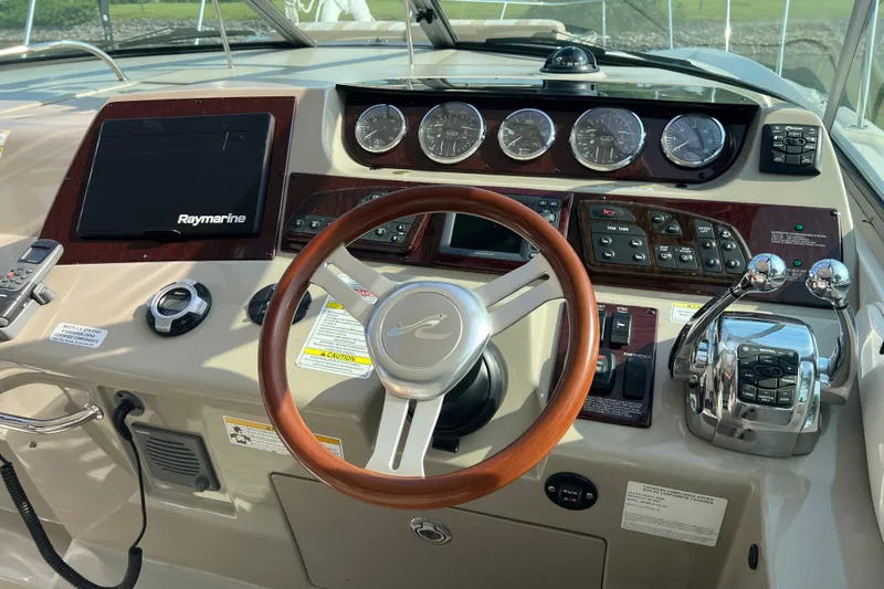  Yacht Photos Pics Cockpit of 2012 Sea Ray 370 Sundancer with steering wheel and control panel.