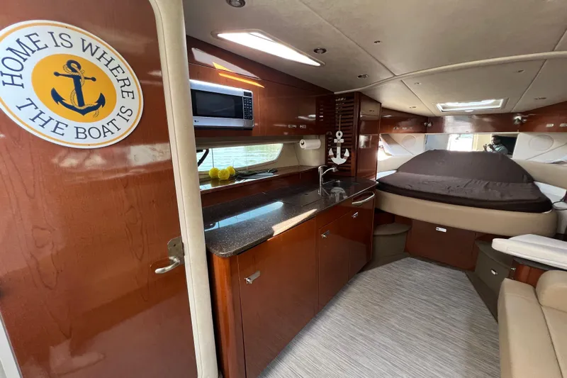  Yacht Photos Pics Interior of 2012 Sea Ray 370 Sundancer yacht with kitchenette and cozy sleeping area.