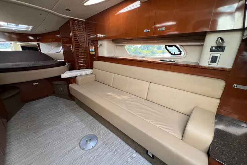  Yacht Photos Pics Luxurious interior of 2012 Sea Ray 370 Sundancer yacht with beige seating and wood finishes.