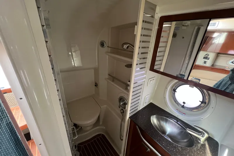  Yacht Photos Pics Luxurious bathroom in 2012 Sea Ray 370 Sundancer yacht with sink, toilet, and porthole window.