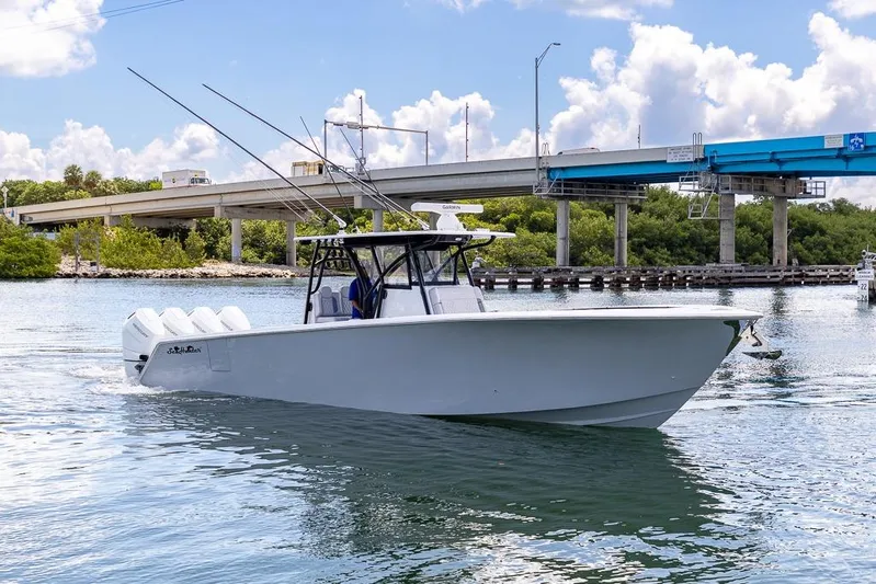  Yacht Photos Pics 2024 SeaHunter 39 Tournament boat cruising under a bridge on a sunny day.