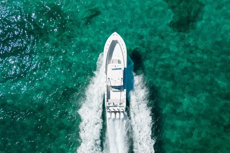  Yacht Photos Pics Aerial view of 2024 SeaHunter 39 Tournament boat cruising on clear turquoise water.