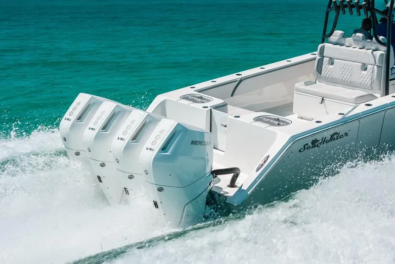  Yacht Photos Pics 2024 SeaHunter 39 Tournament boat with powerful Mercury outboard engines cruising on turquoise water.