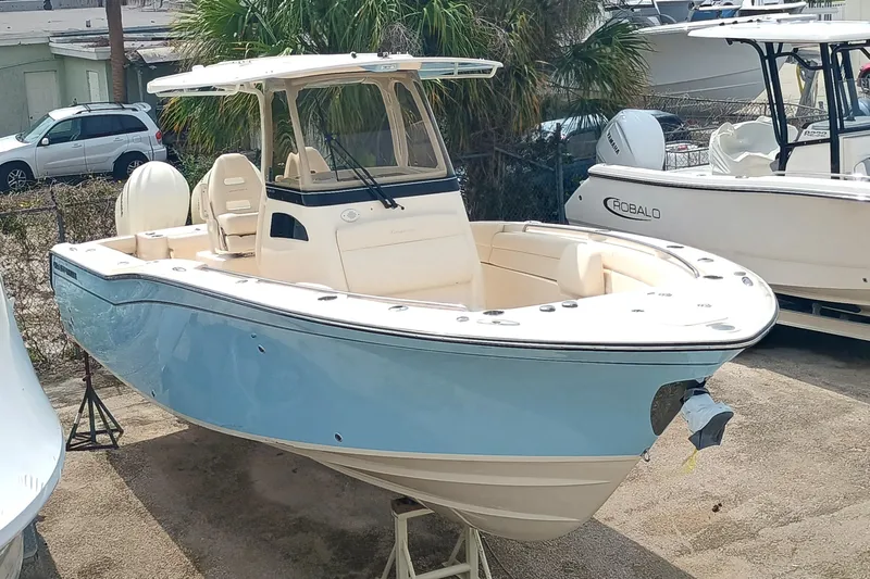  Yacht Photos Pics 2025 Grady-White Canyon 271 boat with light blue hull, docked outdoors.