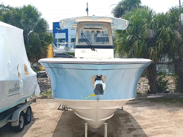  Yacht Photos Pics 2025 Grady-White Canyon 271 boat, front view, parked outdoors with palm trees.