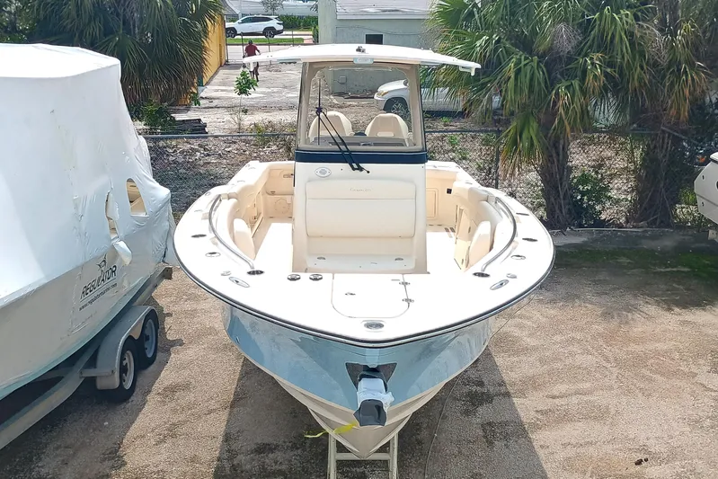  Yacht Photos Pics 2025 Grady-White Canyon 271 boat, parked outdoors, surrounded by trees and other boats.