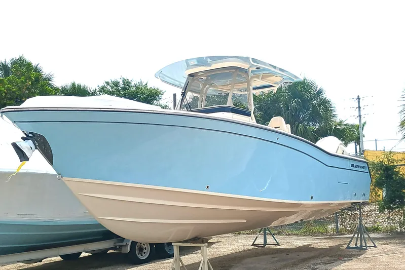  Yacht Photos Pics 2025 Grady-White Canyon 271 boat displayed outdoors on stands.