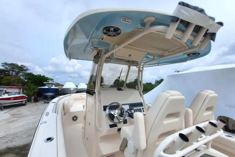  Yacht Photos Pics 2025 Grady-White Canyon 271 boat interior with helm and seating, docked outdoors.