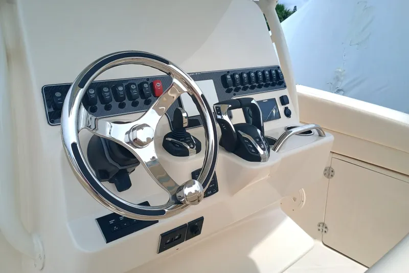  Yacht Photos Pics 2025 Grady-White Canyon 271 boat dashboard with steering wheel and controls.