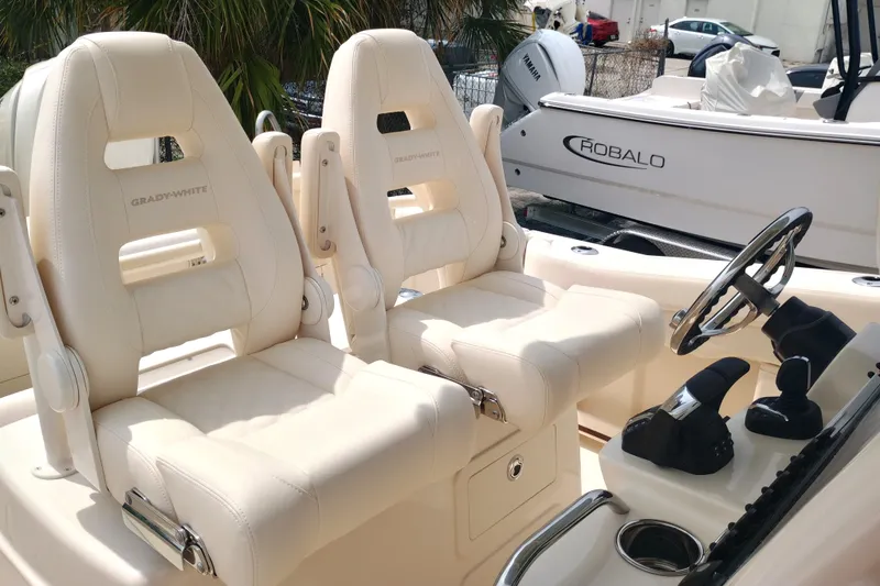  Yacht Photos Pics 2025 Grady-White Canyon 271 boat interior with plush seating and steering console.