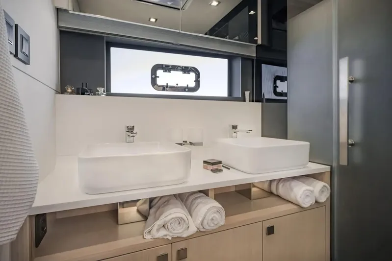  Yacht Photos Pics Luxury yacht bathroom with dual sinks, modern design, and rolled towels on Privilege Signature 650, 2027.