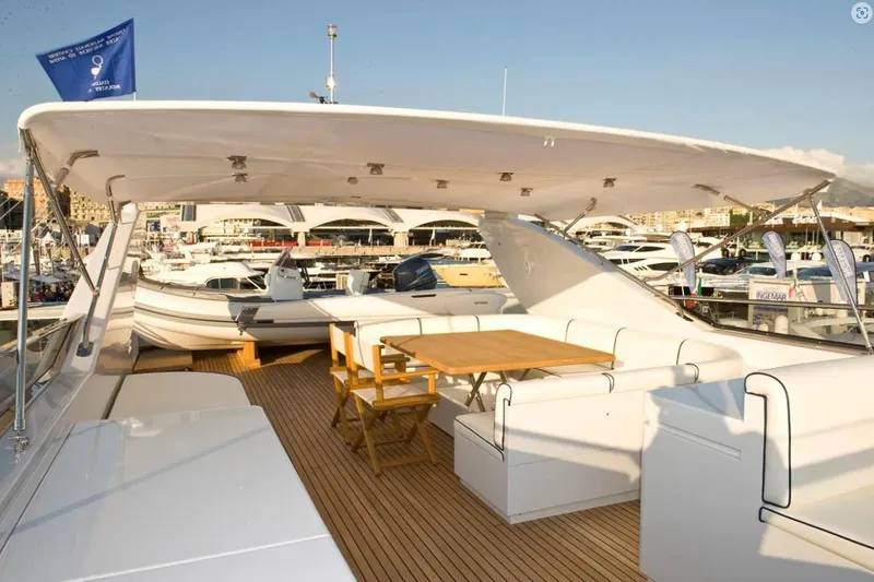 Toi Moi Et Roby Yacht Photos Pics Luxurious 2008 Diano 29 yacht deck with seating and table, docked at marina.