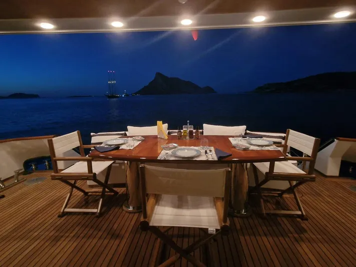 Toi Moi Et Roby Yacht Photos Pics Luxurious dining setup on Diano 29 yacht, 2008, with ocean view at dusk.