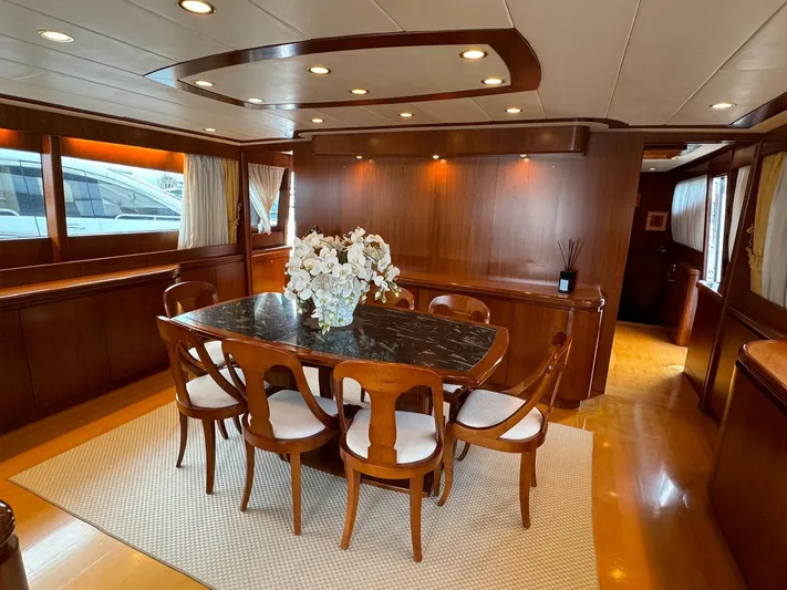 Toi Moi Et Roby Yacht Photos Pics Luxurious dining area on 2008 Diano 29 yacht with elegant wood paneling and floral centerpiece.