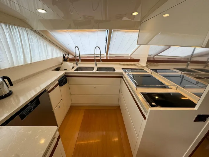 Toi Moi Et Roby Yacht Photos Pics Modern kitchen interior on 2008 Diano 29 yacht with dual sinks and sleek appliances.