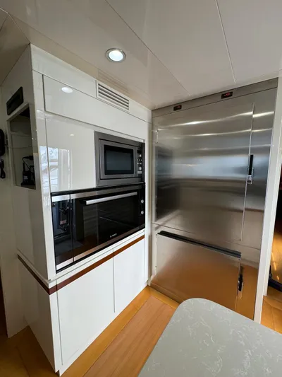 Toi Moi Et Roby Yacht Photos Pics Modern kitchen area in a 2008 Diano 29 yacht with stainless steel appliances.