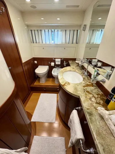 Toi Moi Et Roby Yacht Photos Pics Luxurious yacht bathroom with marble countertop, wooden accents, and modern fixtures in a 2008 Diano 29.