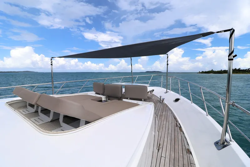  Yacht Photos Pics 2013 Cheoy Lee Bravo yacht deck with sunshade and lounge chairs on open water.