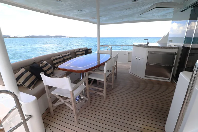  Yacht Photos Pics 2013 Cheoy Lee Bravo yacht deck with dining area and ocean view.
