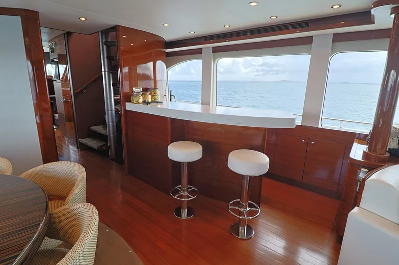  Yacht Photos Pics Luxurious interior of 2013 Cheoy Lee Bravo yacht with bar and ocean view.