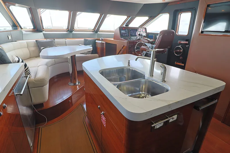  Yacht Photos Pics Luxurious 2013 Cheoy Lee Bravo yacht interior with modern kitchen and seating area.