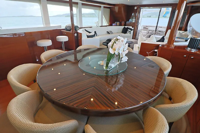  Yacht Photos Pics Luxurious interior of 2013 Cheoy Lee Bravo yacht with elegant dining area and ocean view.