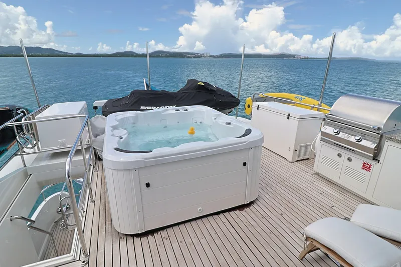  Yacht Photos Pics Luxurious 2013 Cheoy Lee Bravo yacht deck with hot tub, grill, and ocean view.