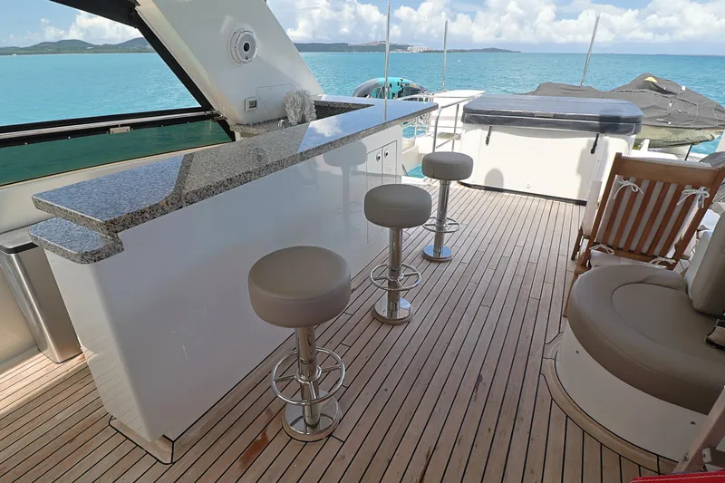 Yacht Photos Pics Luxurious 2013 Cheoy Lee Bravo yacht deck with bar stools and ocean view.