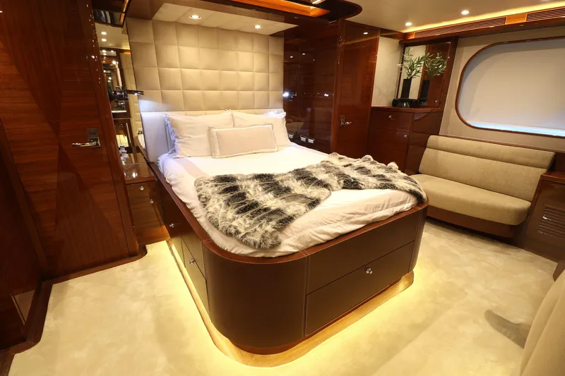  Yacht Photos Pics Luxurious 2013 Cheoy Lee Bravo yacht bedroom with elegant wood finishes and plush bedding.