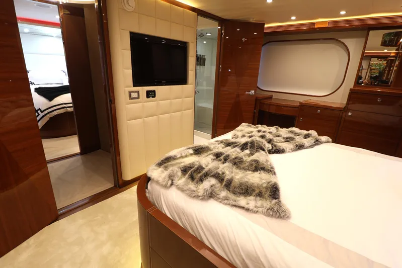  Yacht Photos Pics Luxurious 2013 Cheoy Lee Bravo yacht bedroom with elegant wood finishes and plush bedding.