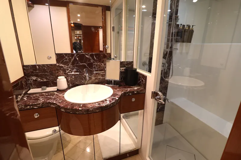  Yacht Photos Pics Luxurious bathroom in 2013 Cheoy Lee Bravo yacht with marble countertop and glass shower.