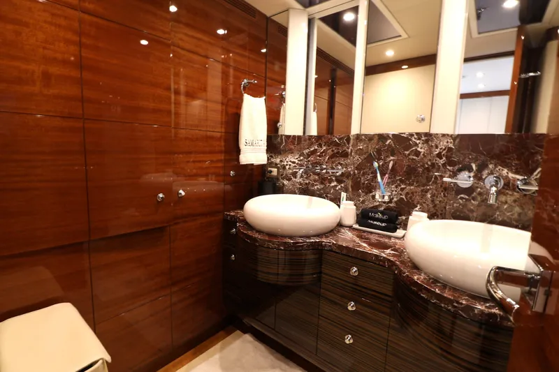  Yacht Photos Pics Luxurious bathroom in 2013 Cheoy Lee Bravo yacht with dual sinks and elegant wood paneling.