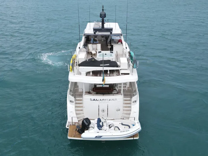  Yacht Photos Pics 2013 Cheoy Lee Bravo yacht on water, rear view with small boat attached.