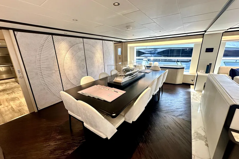 Optimism Yacht Photos Pics Luxurious interior of 2023 Majesty 120 yacht with elegant dining area and modern decor.