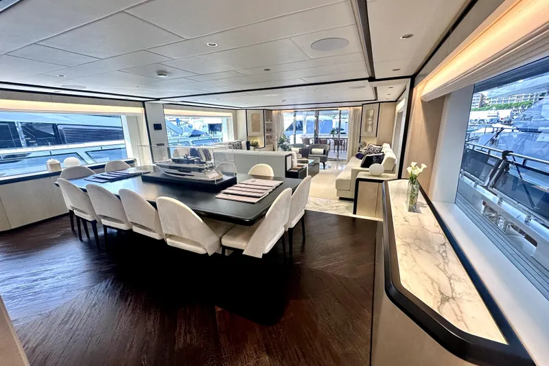 Optimism Yacht Photos Pics Luxurious interior of 2023 Majesty 120 yacht with elegant dining and seating areas.