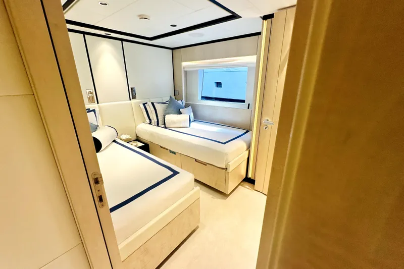 Optimism Yacht Photos Pics Luxurious cabin interior of 2023 Majesty 120 yacht with twin beds and modern decor.