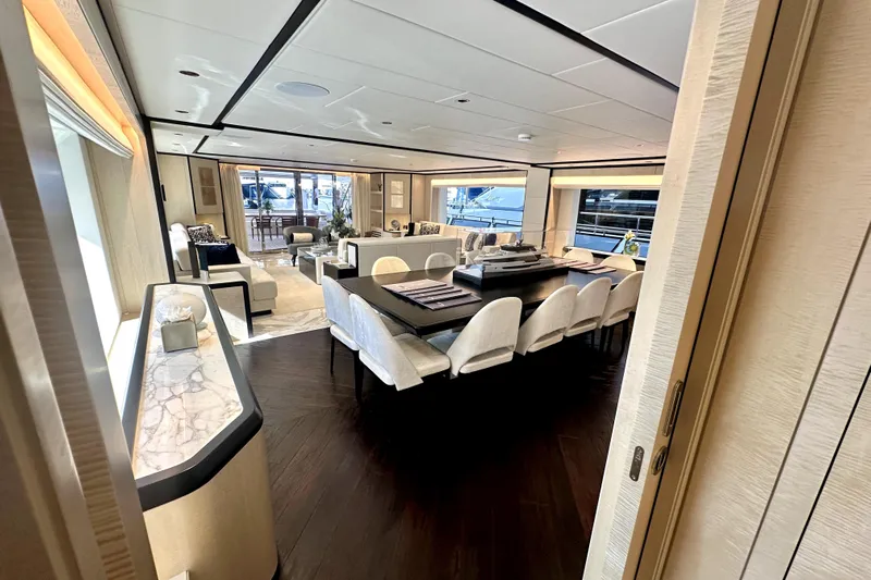 Optimism Yacht Photos Pics Luxurious interior of 2023 Majesty 120 yacht with elegant dining and seating areas.