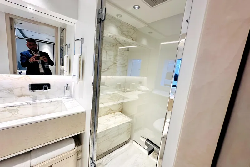 Optimism Yacht Photos Pics Luxurious bathroom in 2023 Majesty 120 yacht with marble accents and modern fixtures.