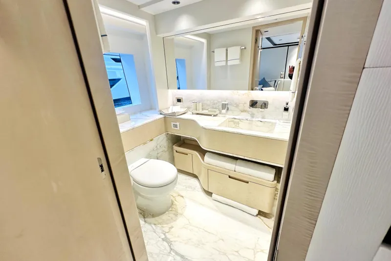 Optimism Yacht Photos Pics Luxurious bathroom in 2023 Majesty 120 yacht with marble accents and modern fixtures.