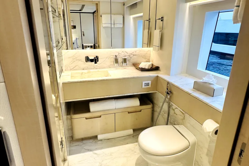 Optimism Yacht Photos Pics Luxurious 2023 Majesty 120 yacht bathroom with marble accents and modern fixtures.